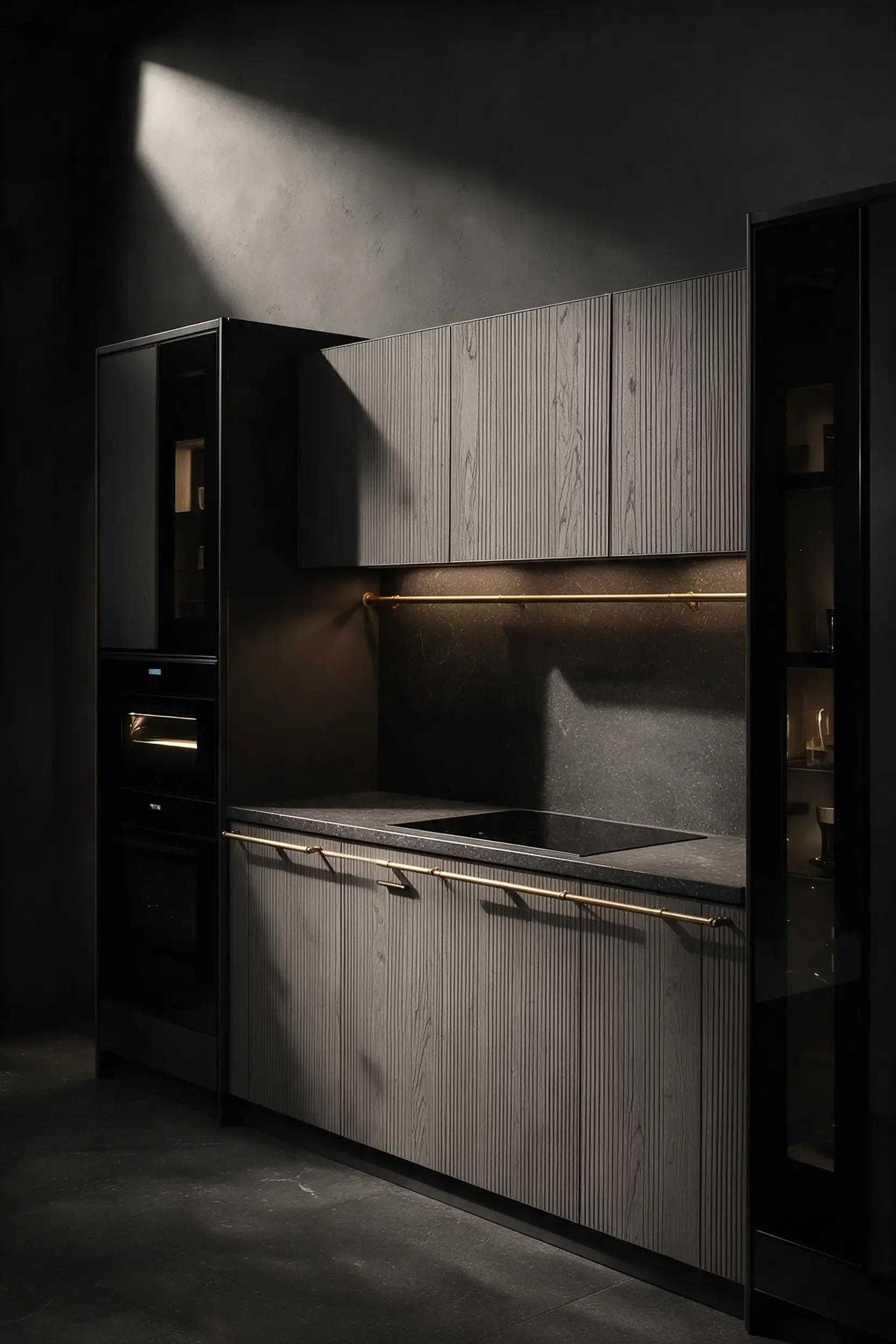 Two full height dark glass appliance columns either side of a compact sink run in grey with a brass tap